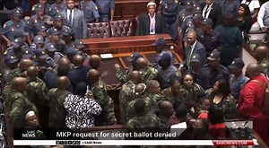 MKP's No-Confidence Motion Against KZN Premier Ntuli Fails Amidst Chaos The motion of no confidence against KwaZulu-Natal Premier Thami Ntuli has failed in the provincial legislature. The MK Party's push for a secret ballot vote ended in defeat as the Government of Provincial Unity maintained its majority. Chaos erupted during the proceedings, with MKP members disrupting debates and demanding a secret ballot. The EFF supported the motion, but the DA opposed it, labeling it "political seizure". P