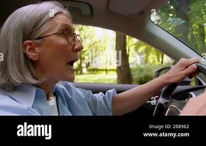 Angry frustrated mad Caucasian mature elderly taxi vehicle driver woman female senior driving car riding inside automobile road rage shouting screaming gesture traffic accident delay commute in city Stock Video Footage - Alamy
