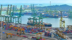 4K Time-lapse video of Container Cargo freight ship with working crane loading bridge in Singapore Port