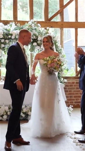 bride and groom walk up the aisle
