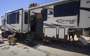 This Toy Hauler RV Was Turned Into a Spacious Home With Two Bathrooms and a Rear Deck