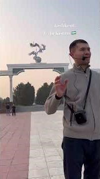 Metal sculpture of storks flying over a globe sits atop arch, symbolizing good & noble aspirations