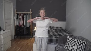 Old woman performing workout exercises to reduce stress during Covid-19 pandemic, prevent coronavirus, healthy elderly female, senior health fitness, stay at home. Age is no excuse to slack health