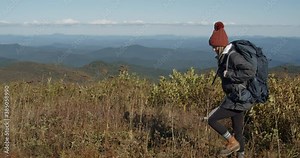 Girl backpacking on top of blue ridge mountains at Black Balsam Knob
