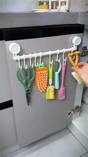 Installing a small hook on a drawer slide inside the kitchen cabinet door is so useful