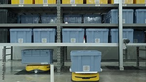 Demonstration of Automated Retail Warehouse AGV Robots Delivering distribution product stock on shelf in modern factory. Smart warehouse Logistics management system with warehouse robot. AI Technology