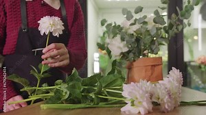 Young Woman Creating a Beautiful Floral Arrangement at a Charming Flower Shop