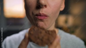 Woman eats a chocolate chip cookies