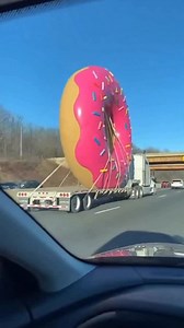Giant Donut Transport Fails… Smashes Into a Low Bridge (Somewhere a Cop Is Crying) 😭🍩 They’re hauling a massive donut down the highway, but don’t calculate the height. It hits a low bridge and gets absolutely destroyed—sprinkles everywhere, chaos on the road. And somewhere nearby, a police officer who loves donuts is mourning the loss. #donut #wtf #viral #funny #fail | The.worldai