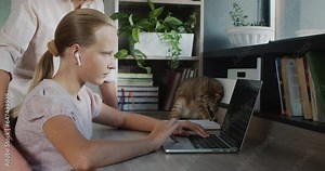 Woman helps a teenage girl do her homework. Education at home concept
