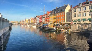 Nyhavn canal with boats, ships and many small colorful houses. Copenhagen, Denmark