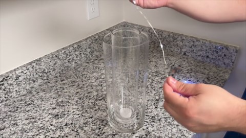 Stick string lights and a Dollar Store vase for this GORGEOUS countertop idea!