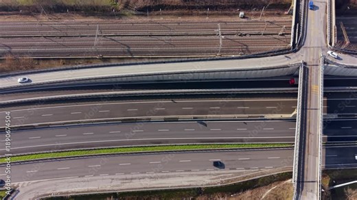 Aerial Highway Crossroads: An elevated perspective captures a complex intersection of highways, with cars navigating the multi-lane thoroughfares and overpasses. A study in urban infrastructure.
