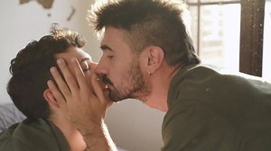Gay couple kissing lying on the bed. LGBT