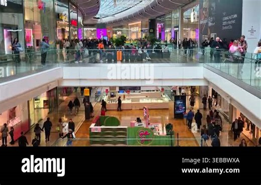 London, UK - October 27, 2025:Crowd of shoppers moving up and down escalators in a shopping center, symbolizing consumer activity, retail environment, busy lifestyle, and modern urban commerce Stock Video Footage - Alamy