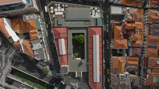 Fast-paced vertical hyperlapse drone descent from high altitude directly toward Mercado dos Lavradores, kept perfectly centered in the frame. The camera moves straight down, creating a sense of depth