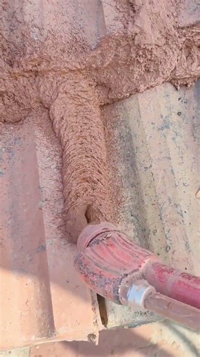 the process of filling colored cement mixture between the roof tiles on a building #construction