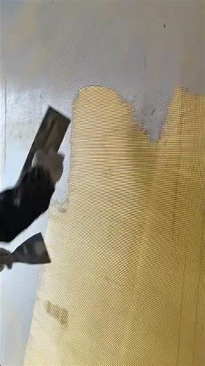 Smoothing the concrete wall surface by applying plaster over a fiberglass mesh to prevent cracking