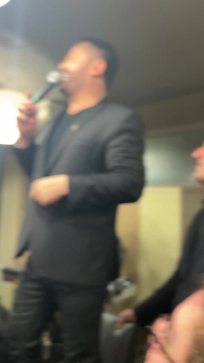 Engaging Speech by a Man in a Black Suit