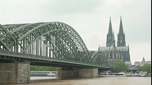 View of cologne cathedral and Hohenzollern Bridge with walking people and ships on Rhine river time lapse. Famous Cologne Bridge