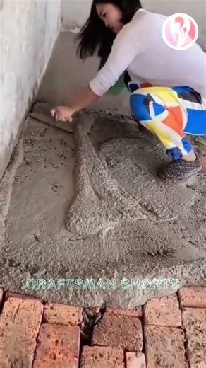 Female bricklayer | A female worker smoothing the cement floor