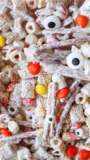🎃 This easy Halloween Chex Mix is the perfect party mix! Totally delicious and simple to make for all your spooky celebrations! 🍿✨ Crunchy, sweet, and so addictive! https://homemadeheather.com/easy-halloween-chex-mix-recipe/ | Homemade Heather