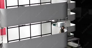 Woman standing on balcony at night using smart phone. Tokyo, Japan