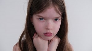 the little girl was offended. Looking at the camera, close-up portrait