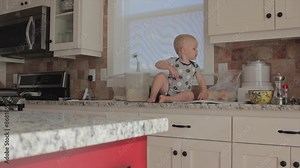 baby boy and his mother in the kitchen