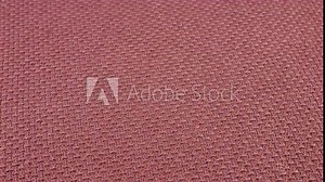 Relief, textured textile background made of purple cotton of antique fuschia shade fabric on a rotating display case. Sewing, fashion and clothing design. Top view.