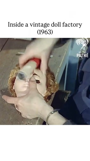 UNIVERSAL KNOWLEDGE on Instagram: "The Instagram reel features a 1963 British Pathé newsreel clip from Battersea, South London, showcasing the labor-intensive vinyl doll production process, including molding heads in eerie molds, hand-painting faces, inserting glass eyes, and assembling limbs with synthetic hair. Narrated with a mix of whimsy and unease—describing the work as "almost macabre" and evoking a sense of being watched—the footage contrasts the dolls' child-friendly design with the unc