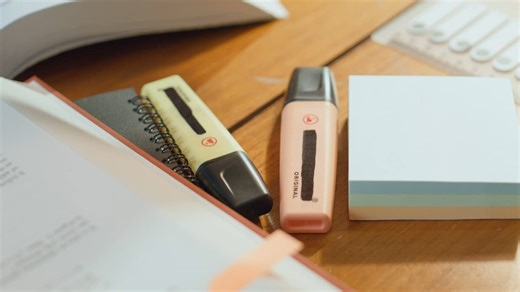 Student hand takes a stiky note to paste it on the notebook  - Free Stock Video