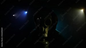 Environmental disaster. Post-apocalyptic survivor in gas mask on a dark background. Dramatic portrait of a man wearing a gas mask. Means for radiation protection. Selective focus Stock Video