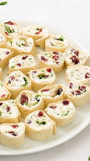These yummy Cranberry Pinwheels Appetizer for holiday gatherings! So delicious and festive with a little orange zest on top! Recipe link in BIO https://reluctantentertainer.com/orange-cranberry-pinwheels-appetizer/ #pinwheels #cranberries🍒 #cranberryorange #cranberrypinwheels #appetizersofinstagram #reluctantentertainer | Reluctant Entertainer