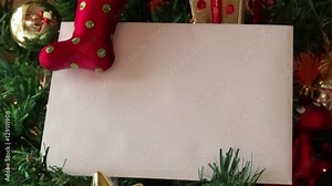 Christmas template background with blank white greeting card for invitation letter or inbound email marketing surrounded by holiday decorations.