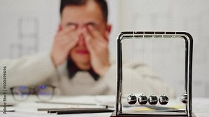 Tired Korean architect designer close-up. Professional engineer, overworked interior creator relaxing after working with new house project, blueprint plan, drafting building.