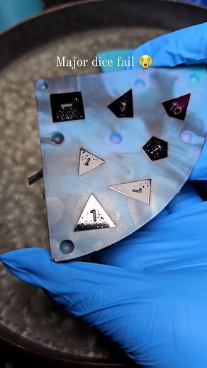 A lot you ask to see fails, here ya go! Unfortunately I made 4 sets of these and they all got riddled with bubbles on the lowest face 😭 So I put them up "as-is" in the usual place. If you want to try to fix em up or don't mind the bubbles. They are very small so I'm wondering if they can be sanded away 🤔 Total bummer because those colors are sooo pretty. I will definitely have to remake them sometime soon 😜 . . . . #dice #dnd #ttrpg #dicemaking #dicefail #handmadedice | Cassiopeia Dice