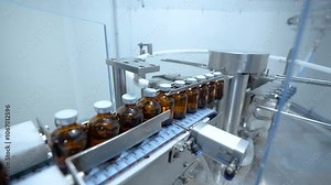 filled vaccine injection manufacturing line glass vial bottle on a conveyor belt in a Pharma production factory injections in small ampoule vials factory process with latest hi tech machinery