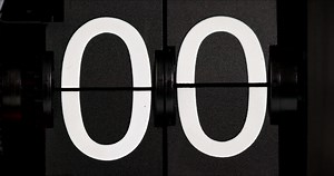 Flip clock Vintage countdown leaves zero to one white numbers on a black background.