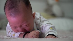 Asia lying down and cry on bed. Parenthood, love, caring concept