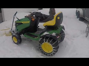 John Deere S170 clearing snow on steep driveway