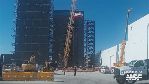 The Starbase GigaBay tower crane construction reached new heights as the cab was lifted onto one of the towers and the turntable already installed. Next up should be the lift and installation of the boom/jib and trolley system. | NASASpaceflight.com