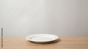 From under the table you can see the hands of a child trying to take an apple from the table.