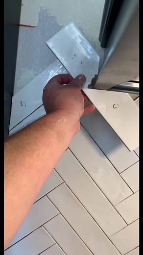 Applying Adhesive Strip to Tiled Walls