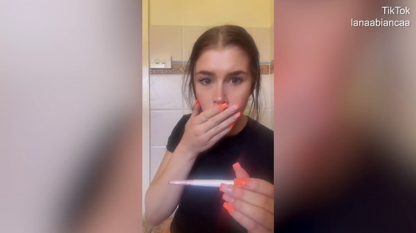 Woman emotional after getting a surprise positive result on her pregnancy test