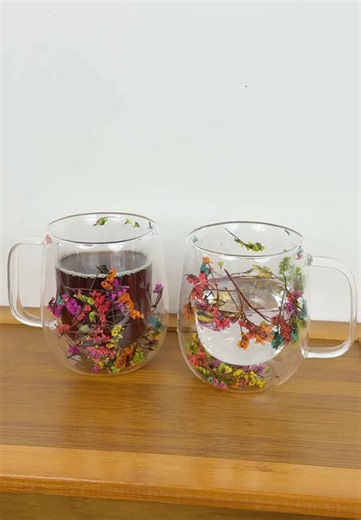 This the prettiest little cup! Double glass lined with flowers floating in between. So unique and gorgeous. 🌺🪻🌻🌸 #flowercup #glasscup #drinkware #prettycup #giftideasforher