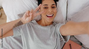 Pov, selfie and woman in bed, happy, wake up and relax in a bedroom, hand and peace sign in her home. Portrait, waking up and black woman pose for photo while resting, lying and having fun alone
