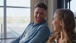Closeup talking pair working laptops sitting together. Two people using devices