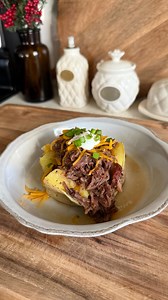 Got leftover pot roast? Turn it into the easiest pot roast baked potato dinner. Add butter and cheese to your baked potato, load it up with the pot roast, then finish with more cheese, sour cream, and green onions. Such a cozy, easy weeknight meal — and the perfect way to use leftover pot roast! #potroast #loadedbakedpotato #dinneridea #weeknightdinner #easydinners #easymealideas | createaplatewithdina