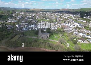 Stoke Gabriel, South Devon, England: DRONE AERIAL VIEWS: Stoke Gabriel village, the Mill Pool, St Mary and St Gabriel church, Devon hills, Dartmoor National Park in b/g; Drone circles r-to-l then ascends; Tilt down view of Church, graveyard & houses Stock Video Footage - Alamy